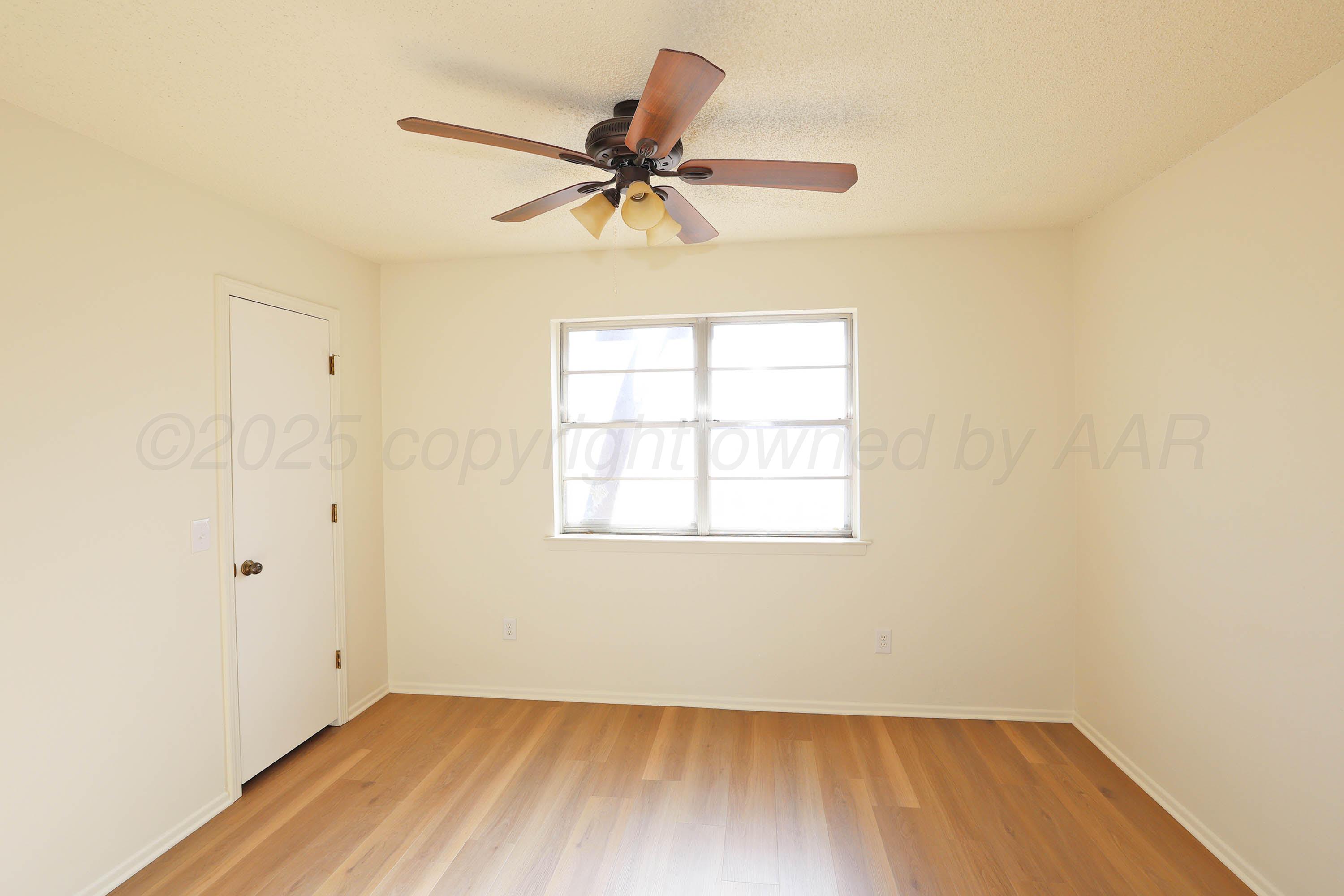 4415 Kingston Road Amarillo, TX 79109 - Photo 17 of 26 an empty room with a window and a fan