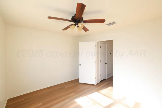 a view of a room with a ceiling fan