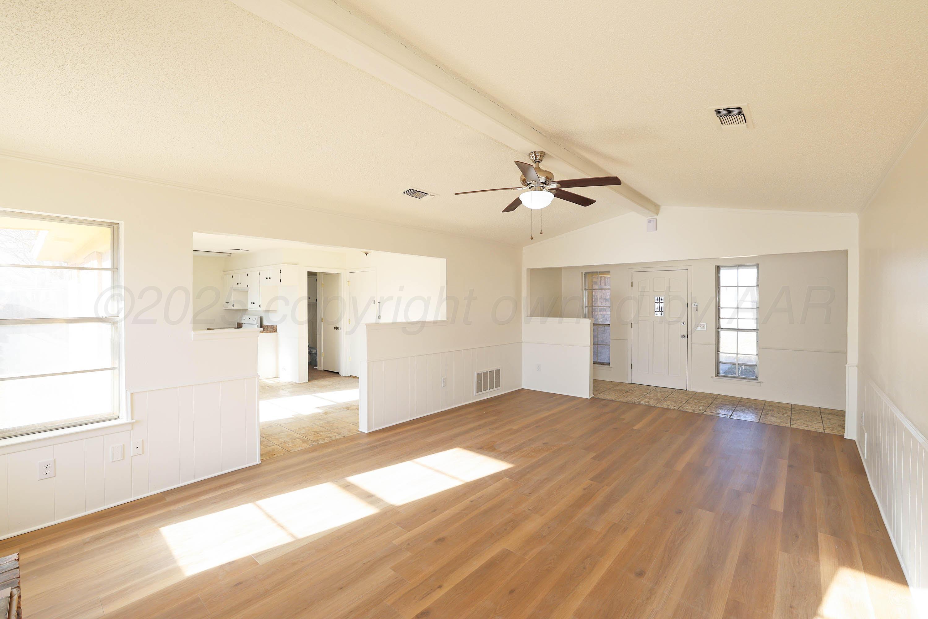 4415 Kingston Road Amarillo, TX 79109 - Photo 5 of 26 a view of empty room with wooden floor and fan