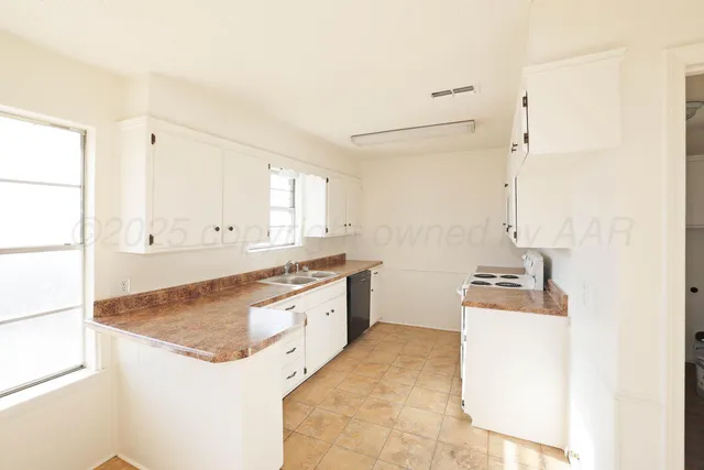a kitchen with a sink stove and wooden cabinets