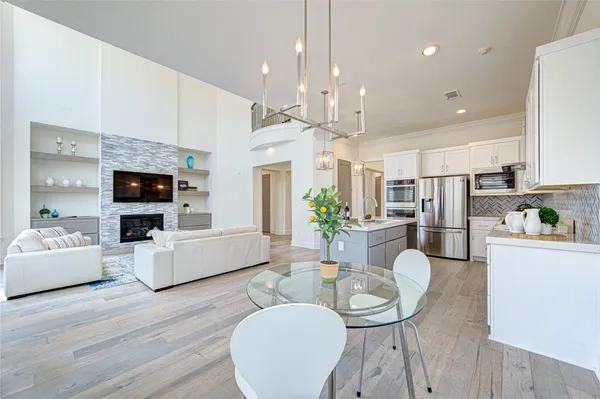 a living room with furniture a flat screen tv and kitchen view