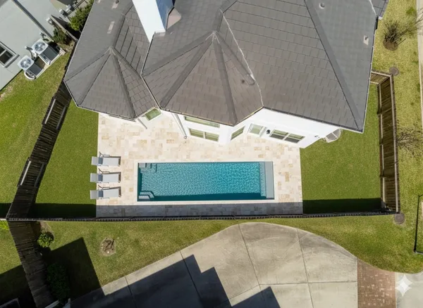 a view of a house with backyard and a tree