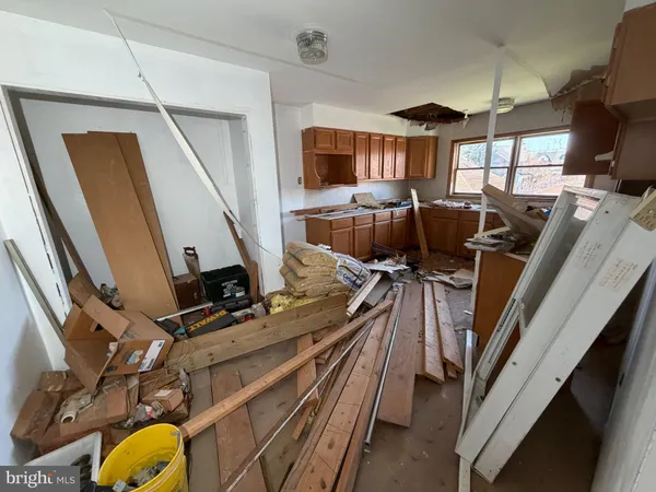 a living room with furniture a flat screen tv and a large window
