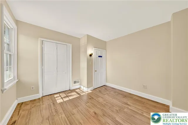 a view of a room with wooden floor