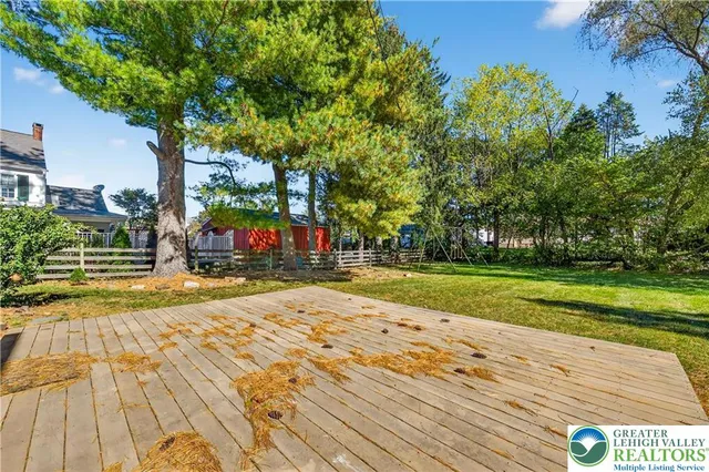 a view of yard with swimming pool and green space