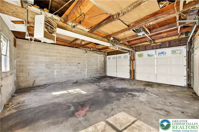 a view of a garage with wooden fence