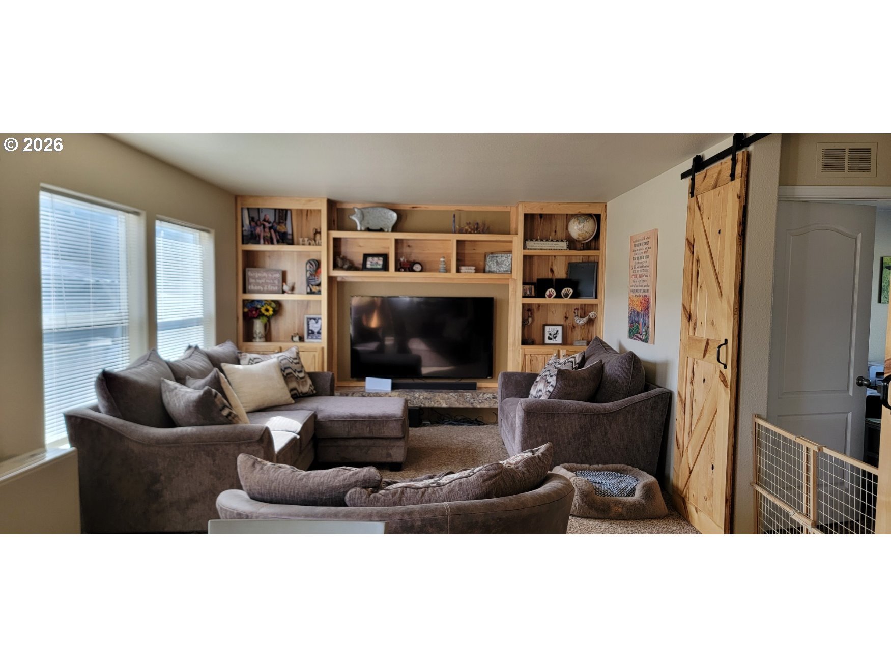 70724 Bear Creek Road Wallowa, OR 97885 - Photo 7 of 44 a living room with furniture a fireplace and a flat screen tv