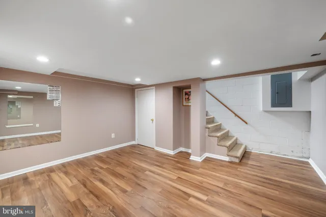 a view of a livingroom with wooden floor and stairs