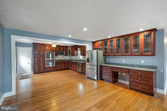 a large kitchen with stainless steel appliances granite countertop a large counter top and oven