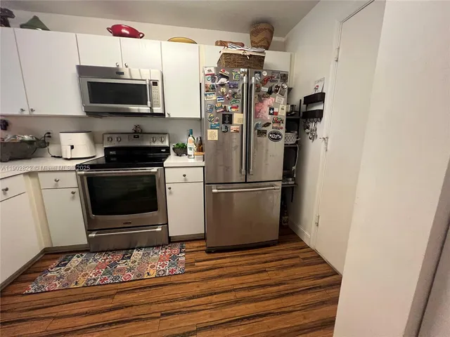 a kitchen with stainless steel appliances granite countertop a refrigerator stove and microwave