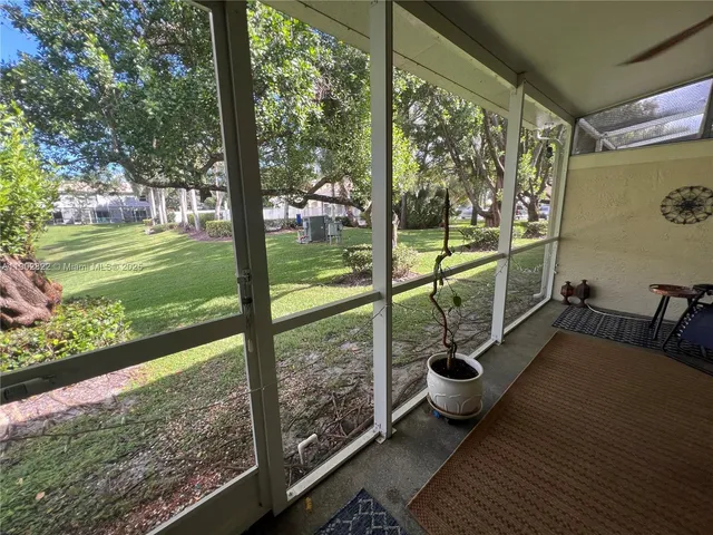 a view of a porch with furniture and garden