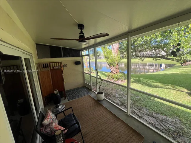 a view of a porch with furniture and garden