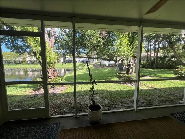 a balcony with wooden floor table and chairs