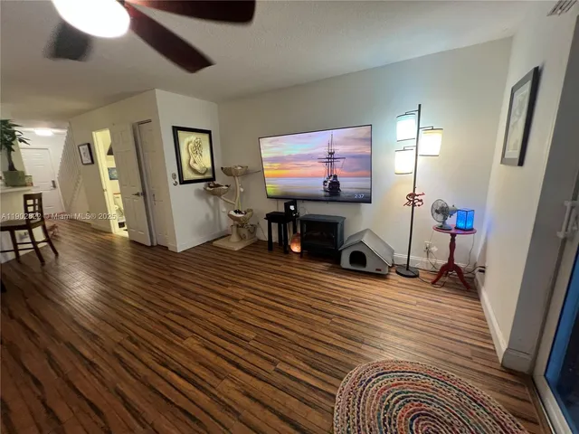 a view of a livingroom with furniture and a flat screen tv