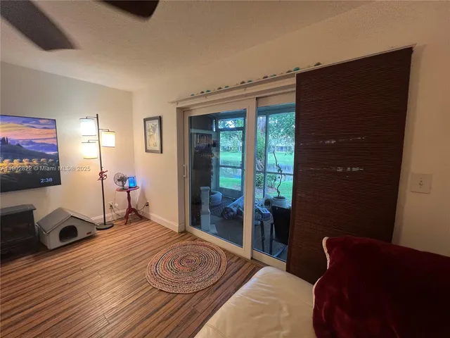 a bedroom with a bed and a flat tv screen on the dresser