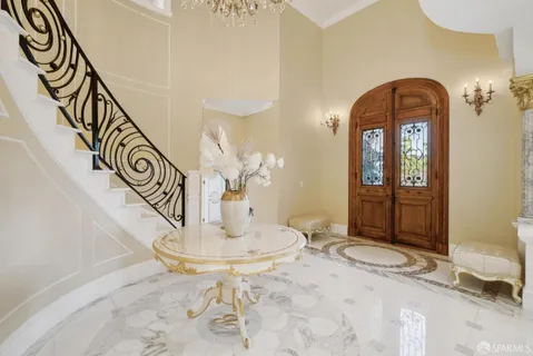 a living room with fireplace furniture and a chandelier