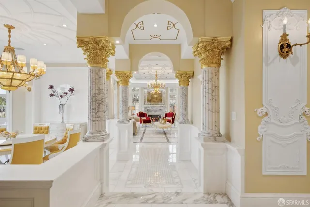 a living room with furniture a fireplace and a chandelier