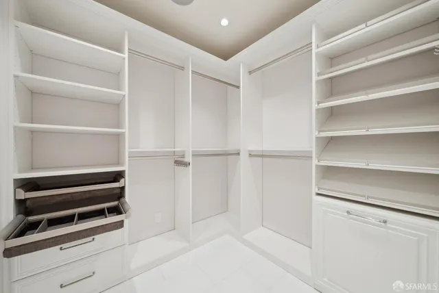 a view of a house with large windows and a large tree