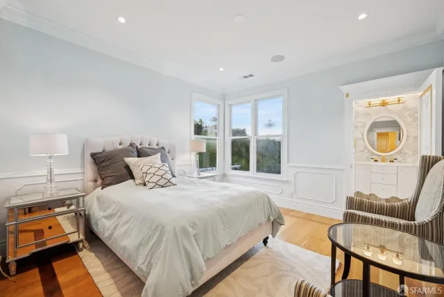 a view of a white building among the with large windows