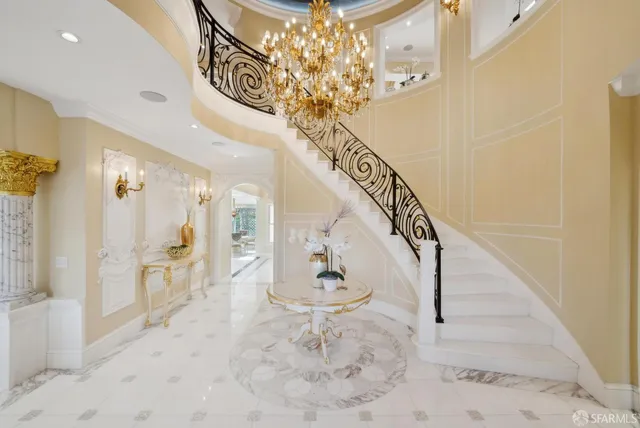 a view of living room with kitchen and chandelier