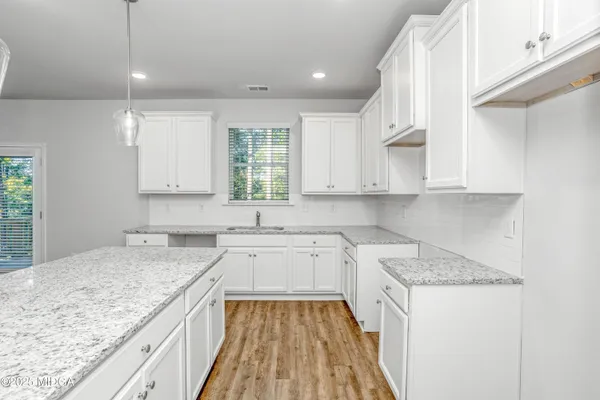 a kitchen with a sink stove and cabinets