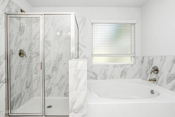 a bathroom with a bathtub and a shower