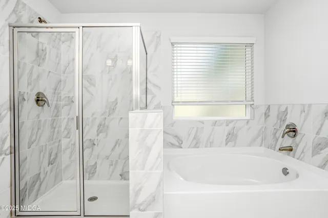 a bathroom with a bathtub and a shower