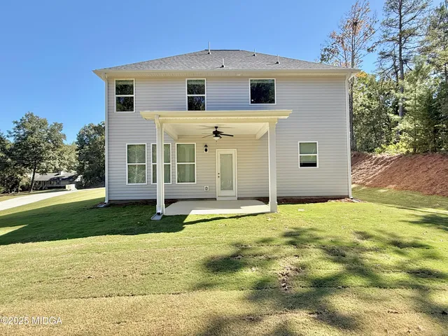 a big house with a big yard and large trees
