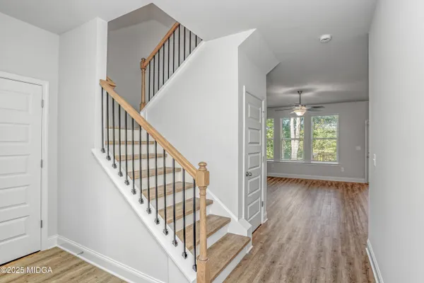 a view of an entryway with wooden floor
