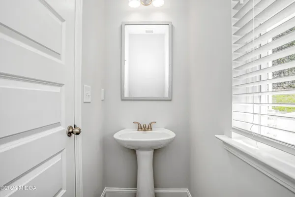 a bathroom with a sink a mirror and a window