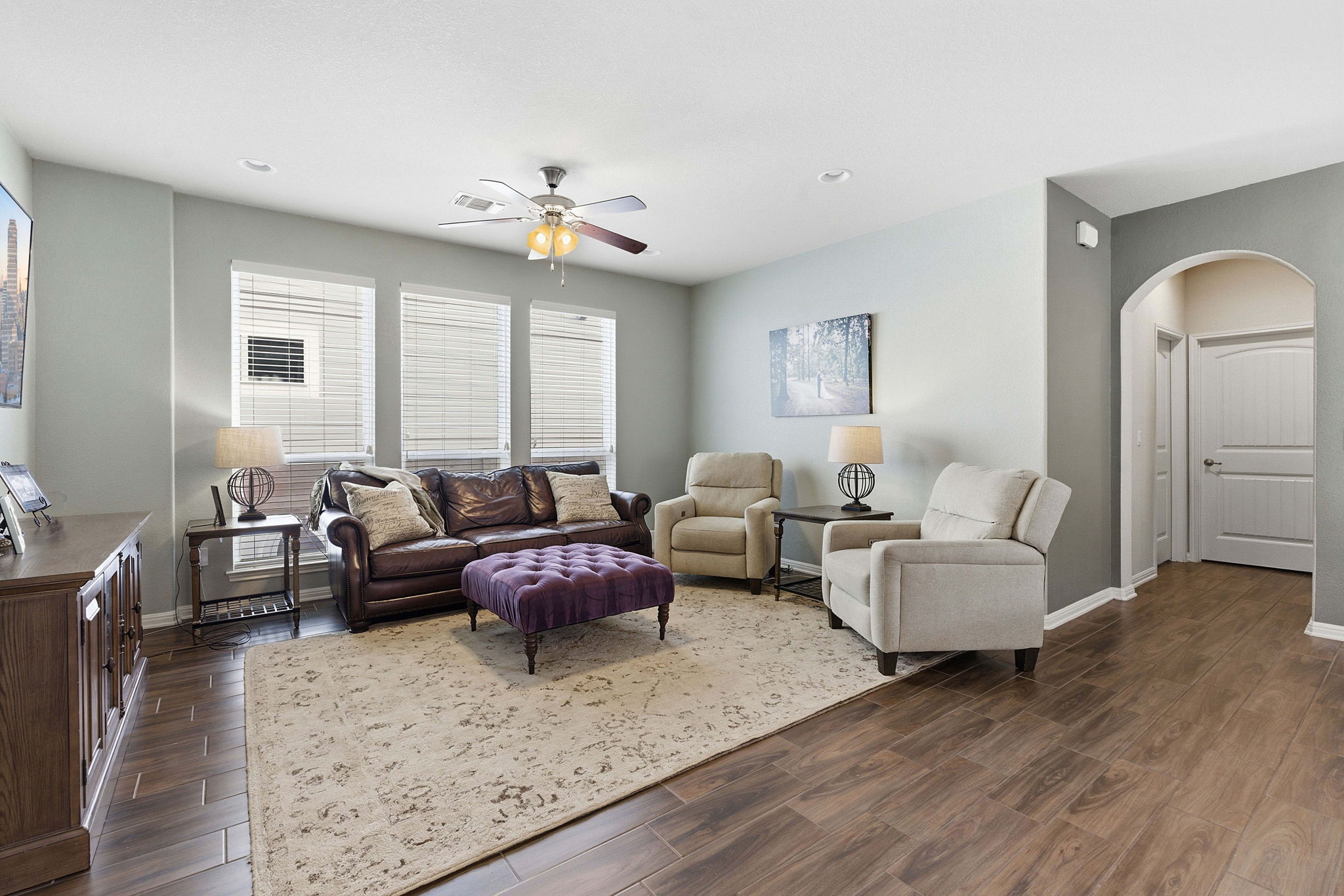 6005 Baythorne Drive Austin, TX 78747 - Photo 12 of 40 Living room with arched walkways, wood finish floors, a ceiling fan, and recessed lighting