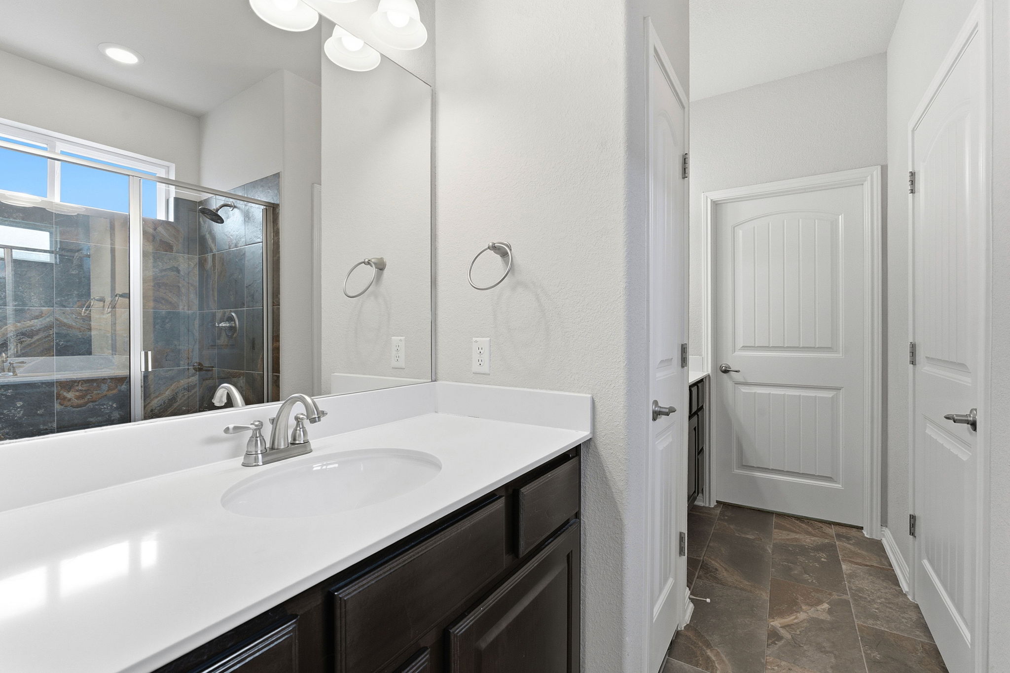 6005 Baythorne Drive Austin, TX 78747 - Photo 18 of 40 Full bath featuring stone finish floors, vanity, and a marble finish shower
