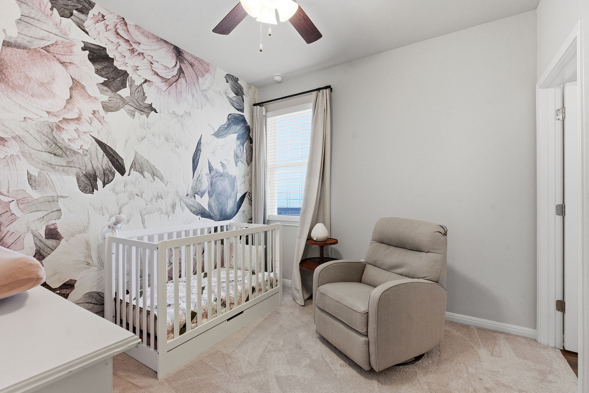 6005 Baythorne Drive Austin, TX 78747 - Photo 22 of 40 Bedroom featuring a crib, ceiling fan, and light carpet