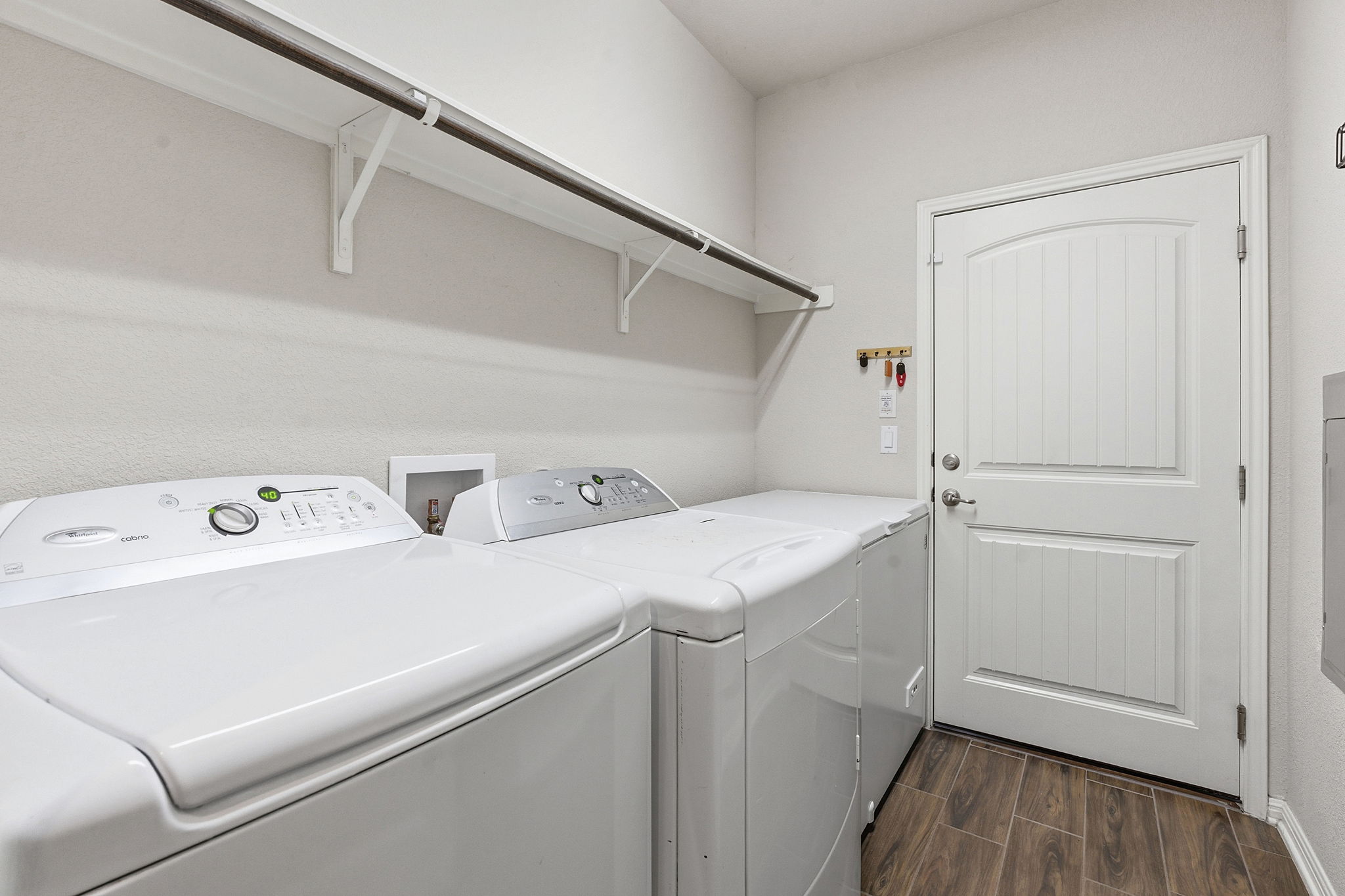 6005 Baythorne Drive Austin, TX 78747 - Photo 24 of 40 Laundry room with wood finish floors and washer and dryer
