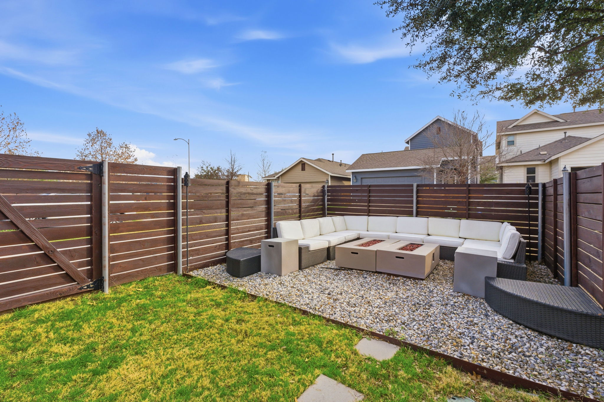 6005 Baythorne Drive Austin, TX 78747 - Photo 25 of 40 Fenced backyard with an outdoor living space with a fire pit