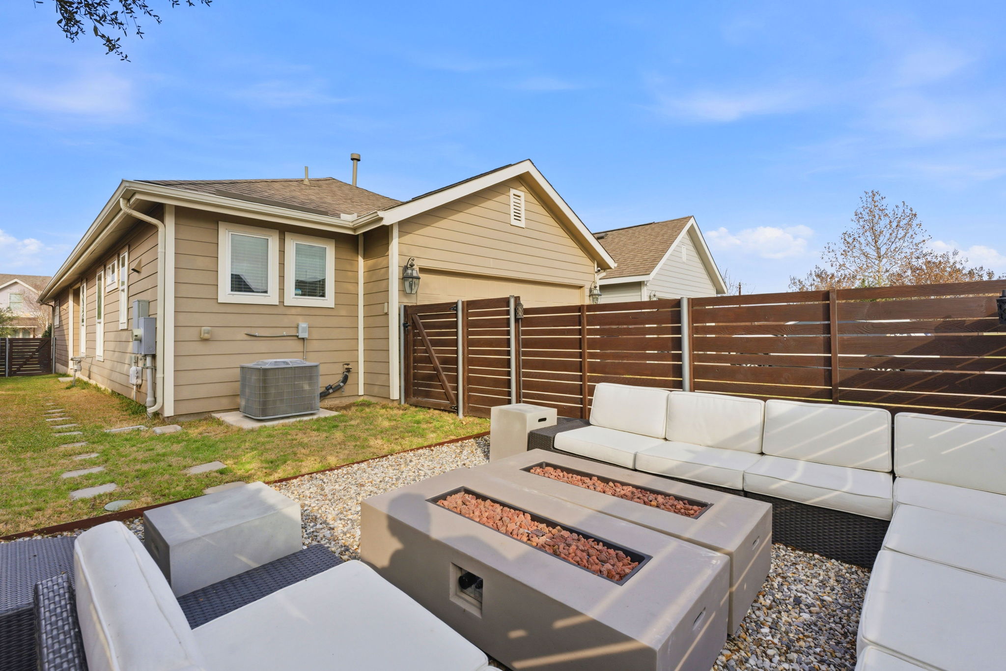6005 Baythorne Drive Austin, TX 78747 - Photo 27 of 40 Fenced backyard featuring an outdoor living space with a fire pit and a patio