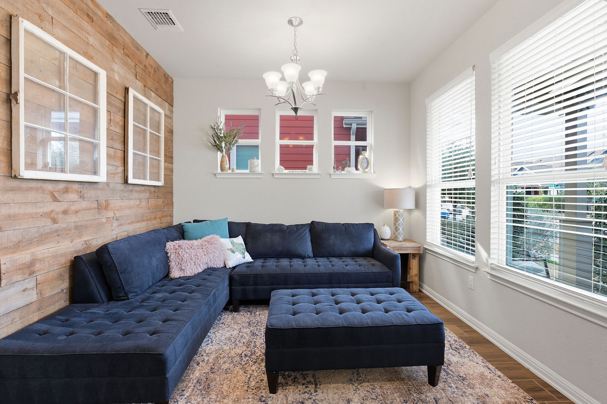 6005 Baythorne Drive Austin, TX 78747 - Photo 3 of 40 Living room with wooden walls, wood finished floors, and hanging lights