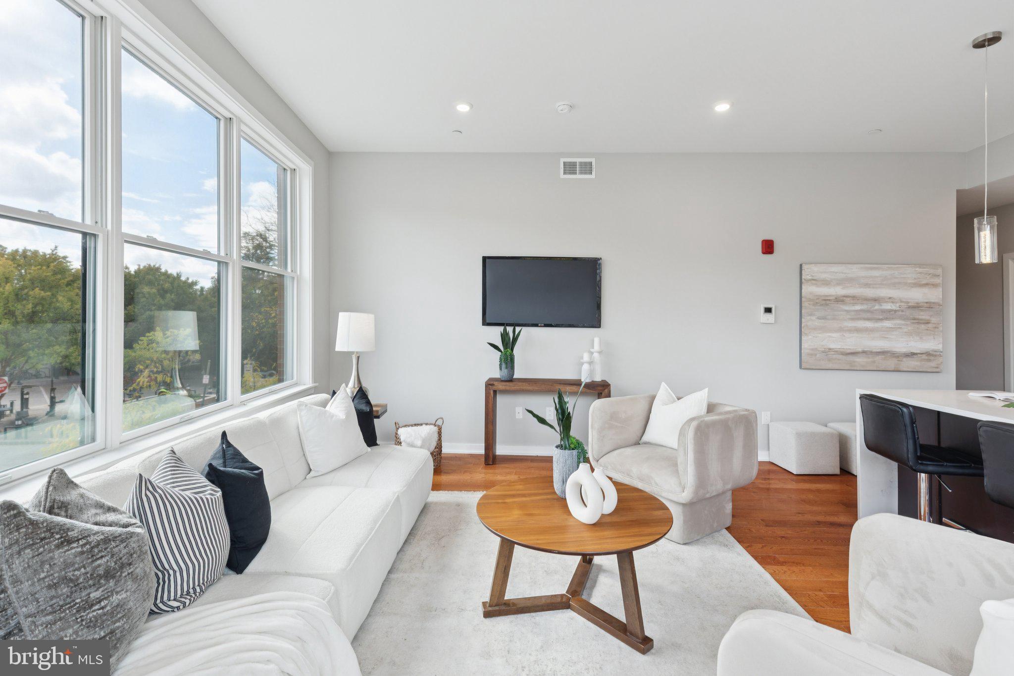100 Forrest Avenue, Unit 203 Narberth, PA 19072 - Photo 12 of 29 a living room with furniture and a flat screen tv