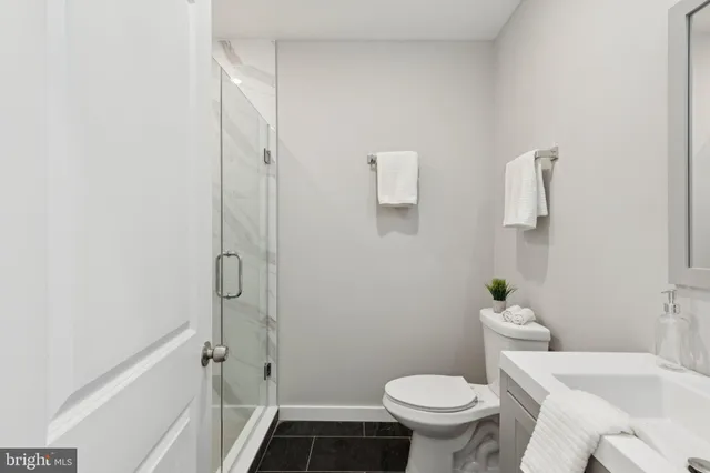 a bathroom with a toilet and a shower