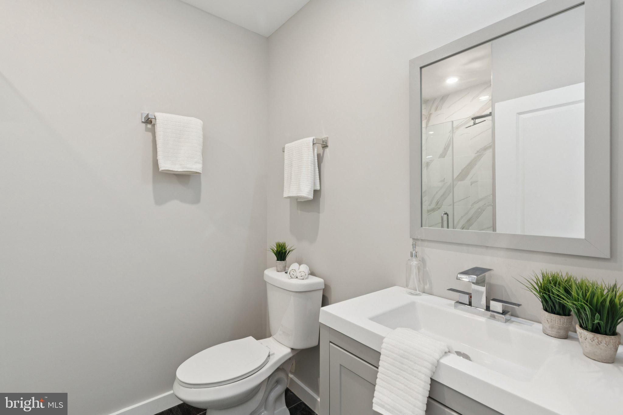 100 Forrest Avenue, Unit 203 Narberth, PA 19072 - Photo 25 of 29 a bathroom with a sink vanity mirror and toilet