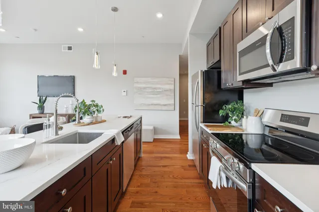 a kitchen with stainless steel appliances granite countertop a sink and stove