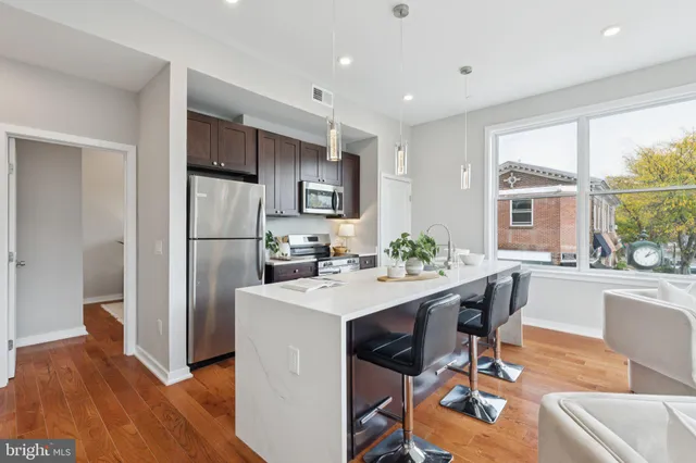 a view of kitchen with dining table chairs and refrigerator
