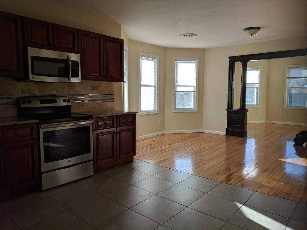 121 Winfield Street Worcester, MA 01602 - Photo 11 of 42 a kitchen with a stove and a microwave