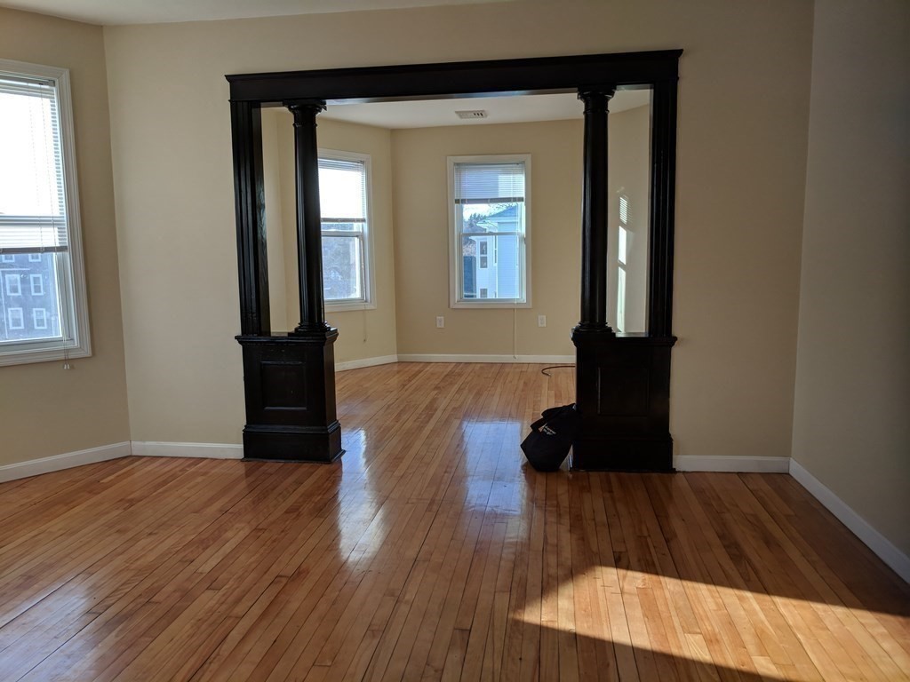 121 Winfield Street Worcester, MA 01602 - Photo 17 of 42 wooden floor in an empty room with a window