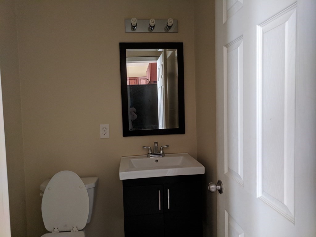121 Winfield Street Worcester, MA 01602 - Photo 22 of 42 a bathroom with a toilet sink and mirror