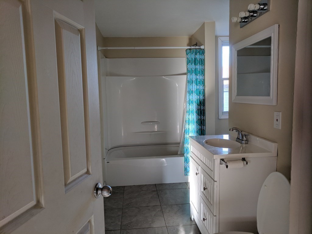 121 Winfield Street Worcester, MA 01602 - Photo 24 of 42 a bathroom with a sink a toilet and tub