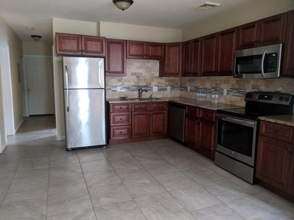 121 Winfield Street Worcester, MA 01602 - Photo 6 of 42 a kitchen with a refrigerator sink and microwave