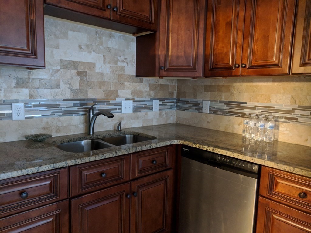 121 Winfield Street Worcester, MA 01602 - Photo 10 of 42 a kitchen with granite countertop a sink and cabinets
