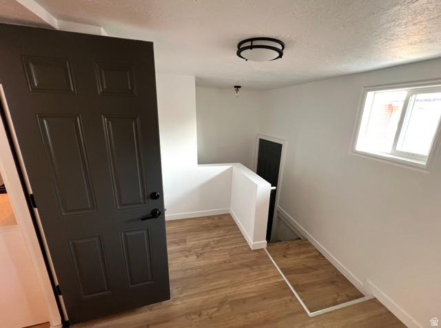 545 23rd Street Ogden, UT 84401 - Photo 15 of 28 Entry space featuring wood-finish flooring, a contemporary flush mount light fixture, and a window with white trim
