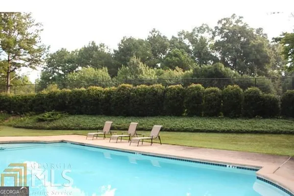 a view of a swimming pool with a yard